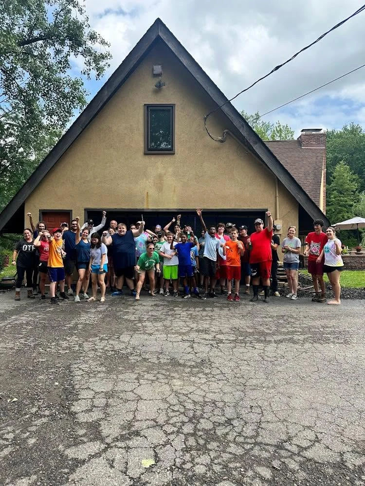 Willow Farms students and staff cheering outside the farm